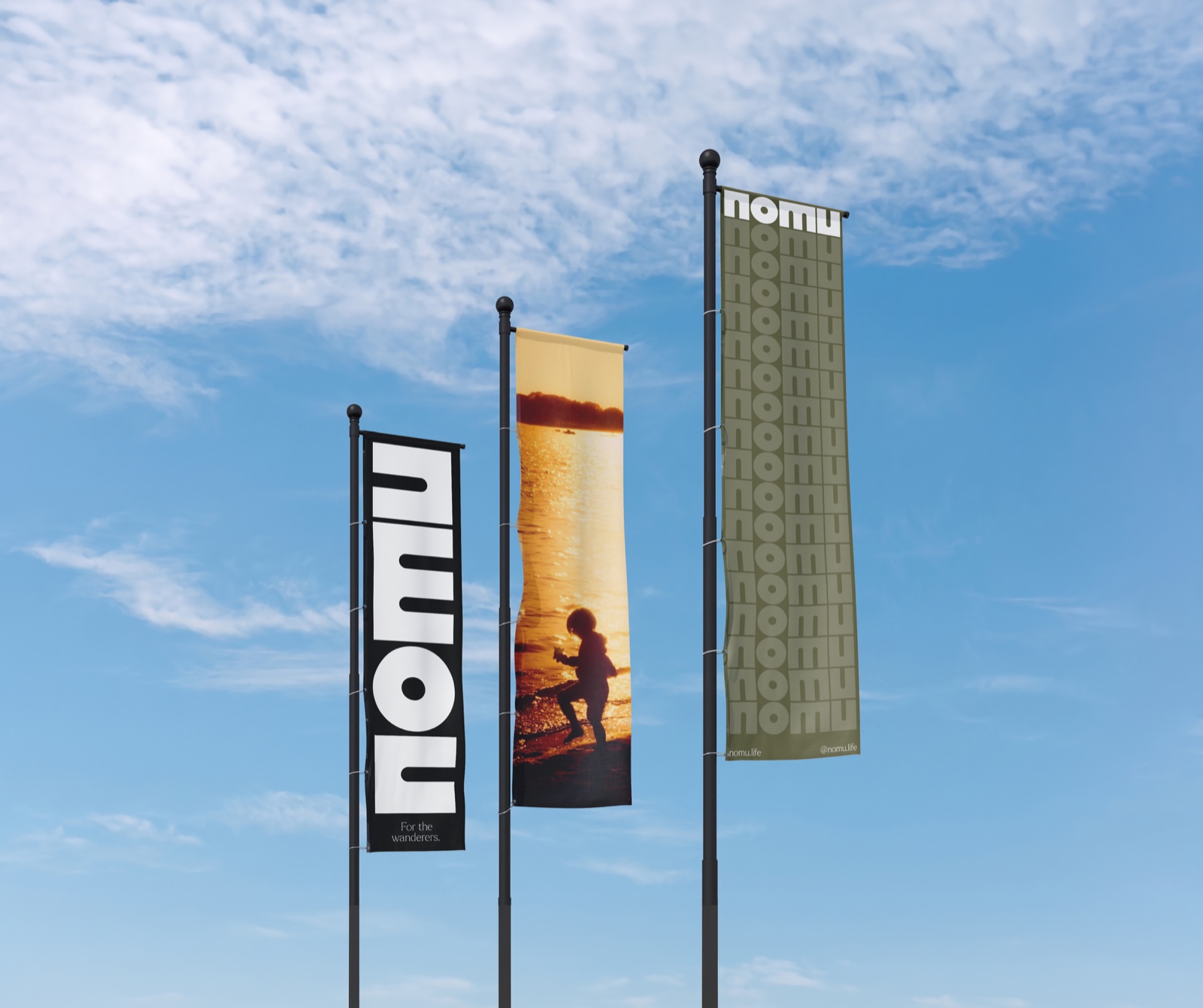 Three Nomu flags against a blue sky