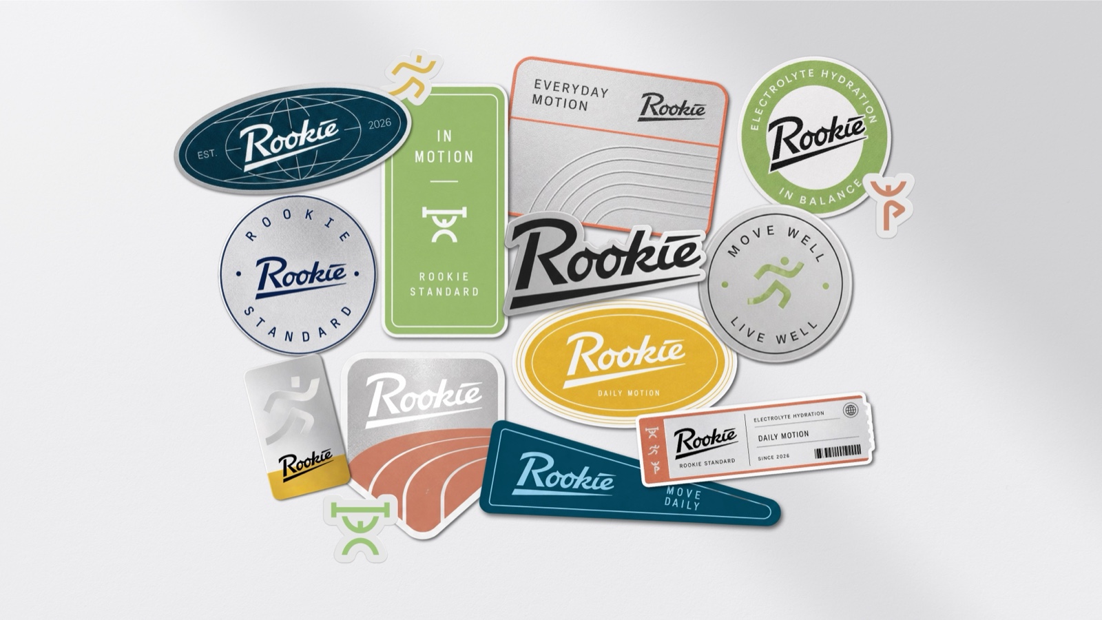 A pile of Rookie badges and vinyl stickers on a grey wall