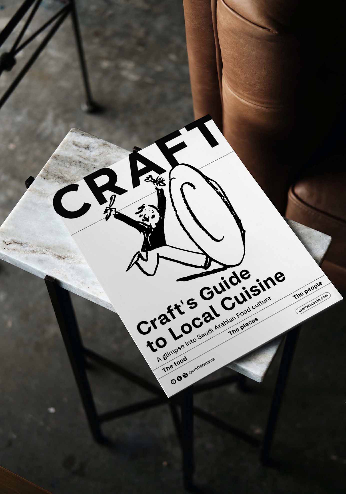 Craft's Guide to Local Cuisine booklet on a marble side table